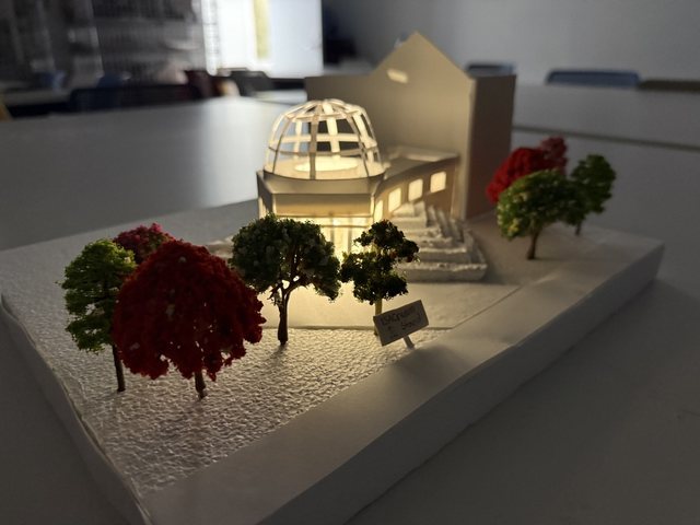Model of the ice cream stand with a domed glass lantern, red and green model trees on a white base