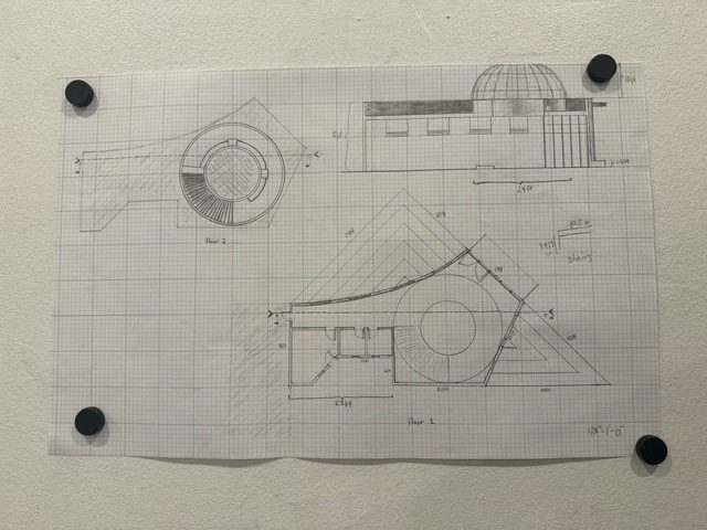 Pencil plan and section drawings on graph paper held down at the corners