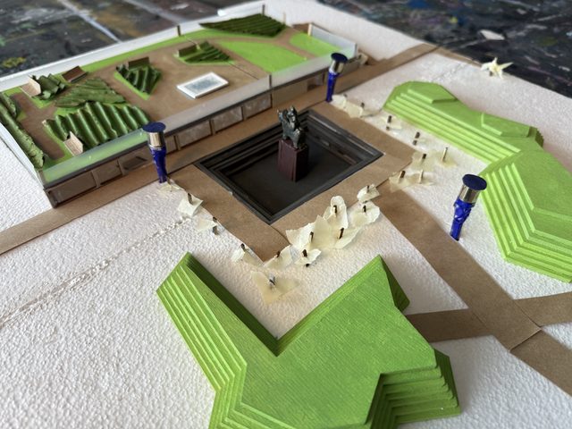 Overhead view of the finished model showing the sunken courtyard, statue plinth and angular green terraces